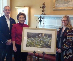 Craig Kandravi (from left), club steward of Radnor Hunt; event co-chair Renny Wood of Chadds Ford; and decorations chair Jane Taylor of Berwyn show off the signed Frolic Weymouth print that will be auctioned at the gala.