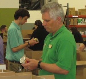 Wegmans  Downingtown Store Manager Kurt Hasebo participates in the sorting regimen necessitated by his company's massive donation to the Chester County Food Bank.