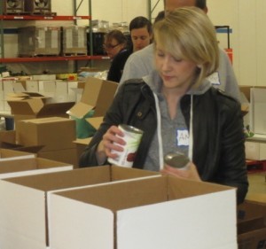Amy Strauss from the Town Dish checks the expiration date on one of the hundreds of cans that needed to be sorted.